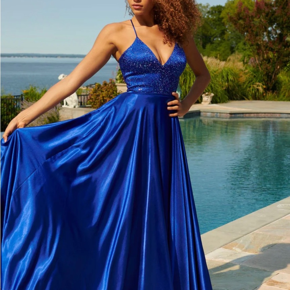 Pagent-Prom Dress Faviana size 4. Never worn. Still has the bag. Cobalt blue.